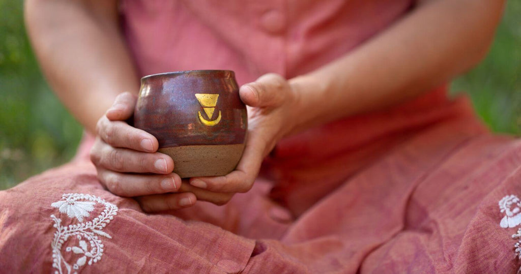 Simple cacao ceremony at home - woman holding a mug of Ceremonial Cacao