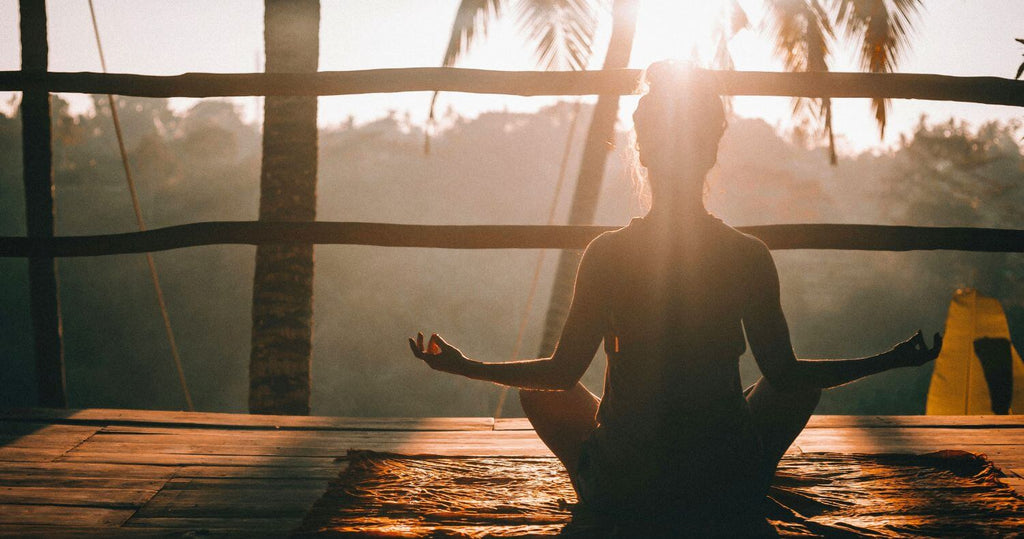 The health benefits of cacao. A person sitting meditating with increased focus and vitality after drinking a sacred ceremonial cacao drink.