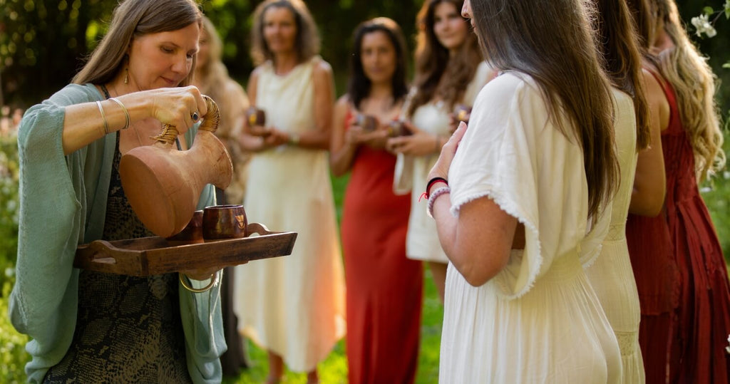 Sjha'ra serving cacao in group ceremony