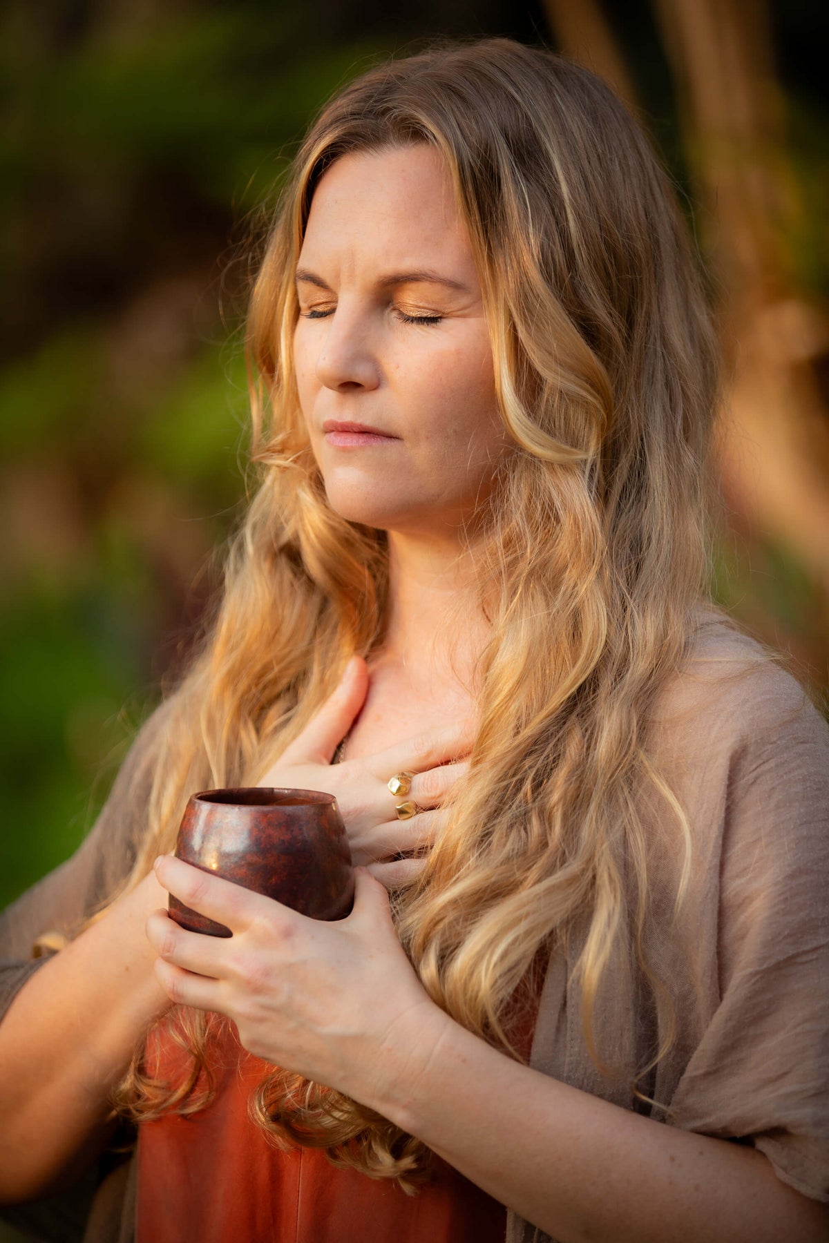 A woman deep in ceremony, feeling the heart opening of REAL, 100% pure ceremonial cacao and reverence for the sacred cacao plant.