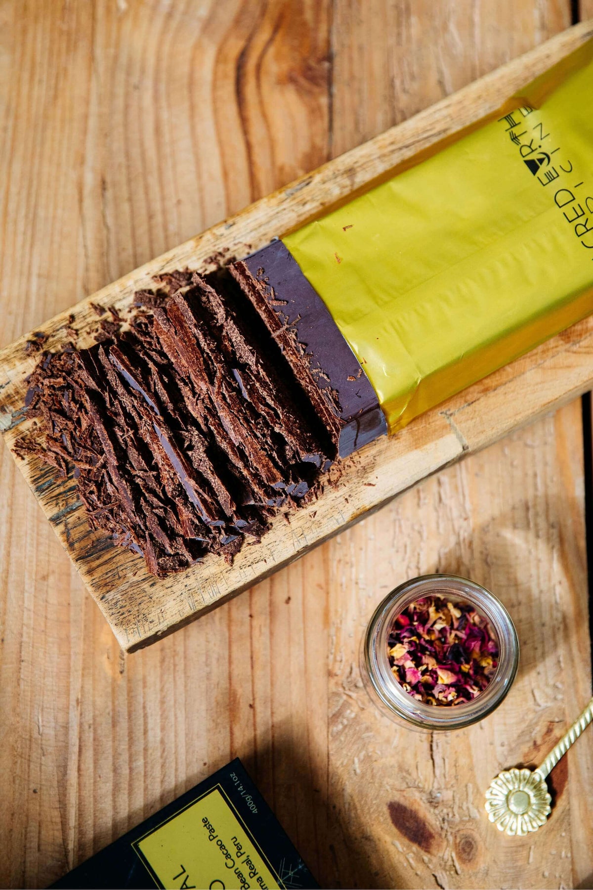 A 100g Sacred Earth Medicine Ceremonial Cacao starter block unwrapped and finely chopped, ready to make a sacred hot chocolate.