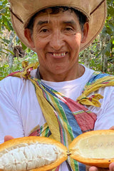 Peruvian farmer holding a beautiful open chuncho cacao pod direct from the tree. Delicious!