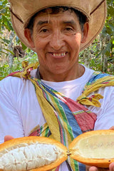 Peruvian farmer holding a beautiful open chuncho cacao pod direct from the tree. Delicious!
