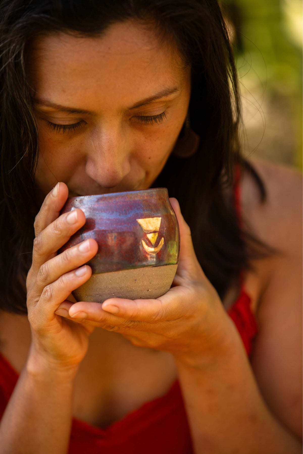 A beautiful woman drinking delicious Sacred Earth Medicine cacao from a regular size SEM cup 